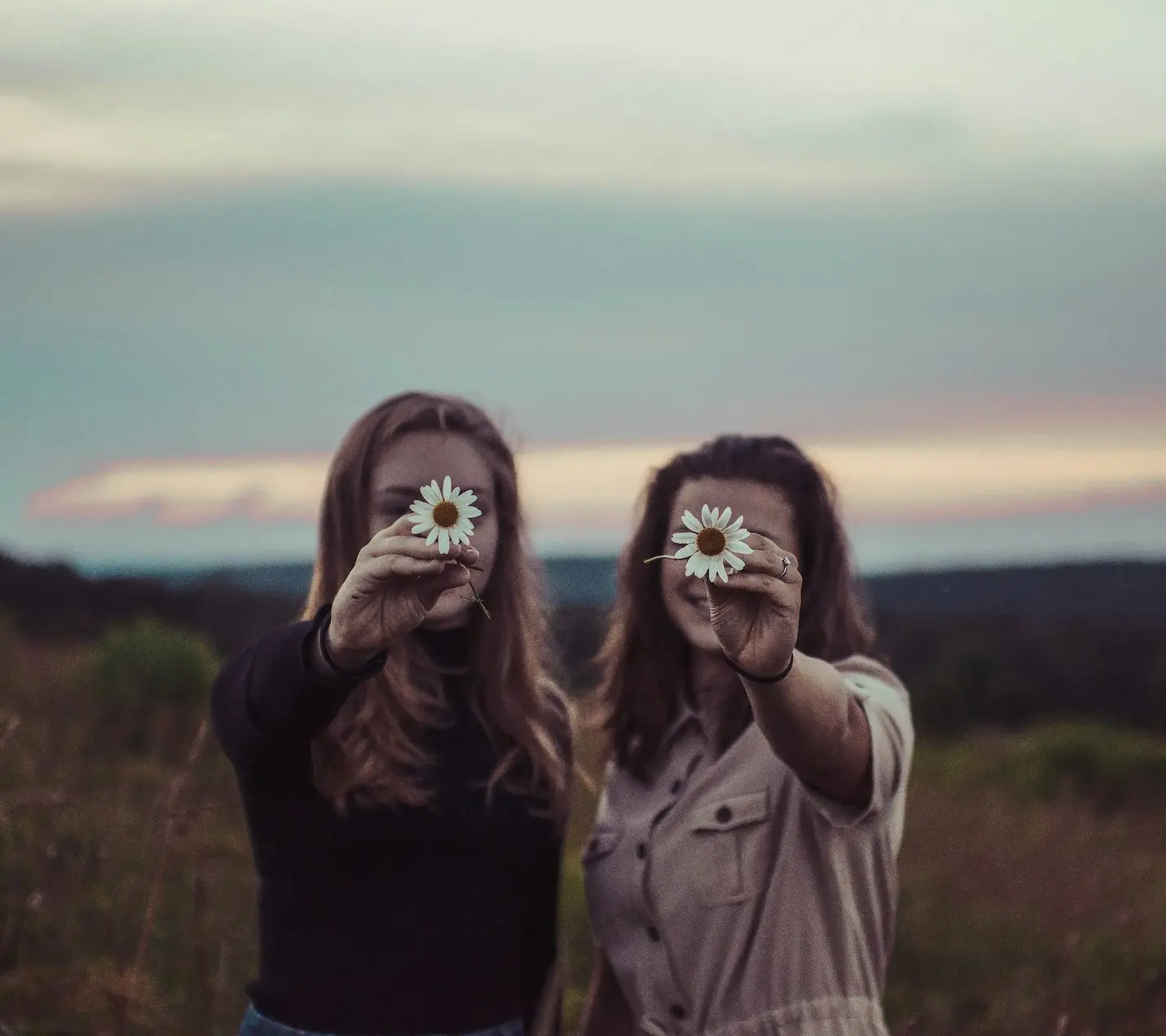 two women holding flowers